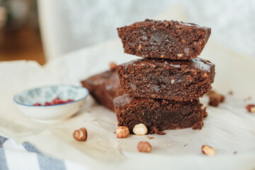 Sliced chocolate brownie with hazelnut lined up one on top of the other. Side view close up. Chocolate delicious concept