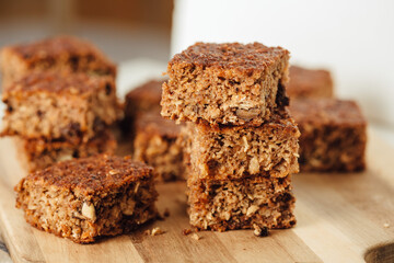 A close up of four slices of apple and walnut bread. Arranged on the wooden board. Close up side view
