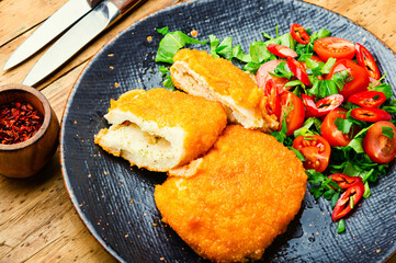 Chicken kiev cutlet with salad