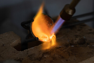 Melting and pouring Silver at Jewelers Workshop. Recycling Precious Metals