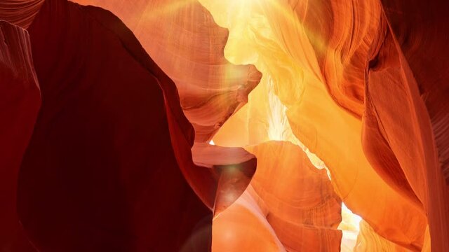 Red and orange walls of Antelope Canyon in Arizona, USA, United States. Zoom out shot of Antelope Canyon with rays of the midday sun and glare