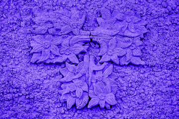 Blue bas-relief on the wall. Sunny summer day. Front view.