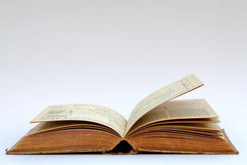 Open old book with text on white background