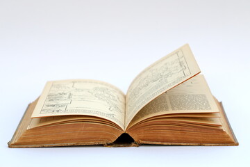 Open old book with text on white background