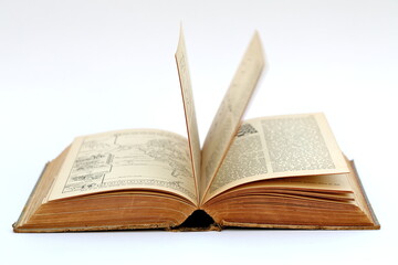 Open old book with text on white background