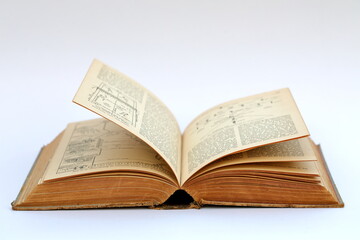 Open old book with text on white background