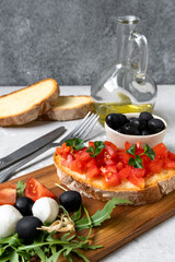 Italian bruschetta with tomatoes, olive oil, green parsley and pink pepper. typical Italian antipasti starter in a restaurant in Italy Rome Milan. tomato bruschetta recipe, selective focus