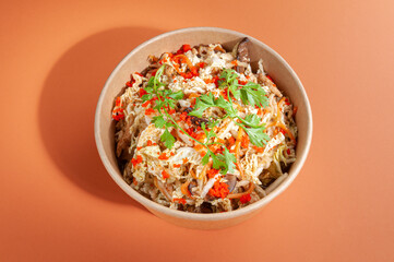 Salad with Chinese cabbage, shitaki mushrooms and masago cut. In sweet and sour sauce. In a food delivery plate. Close-up. View from above. Isolated.