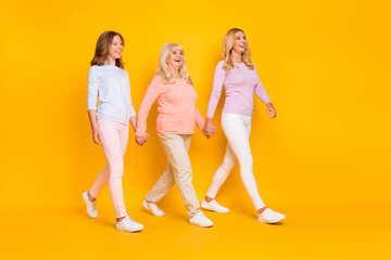 Full size profile photo of optimistic three woman grand mom daughter go wear pastel cloth isolated...
