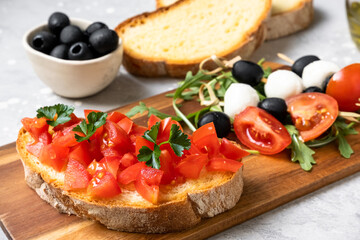 Italian bruschetta with tomatoes, olive oil, green parsley and pink pepper. typical Italian antipasti starter in a restaurant in Italy Rome Milan. tomato bruschetta recipe, selective focus