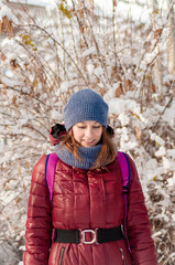 Winter portrait of a girl. Girl in warm clothes. Portrait of a woman in a winter park.
