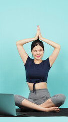 Fitness influencer. Sporty woman Blogger. workout training online via laptop. blue green...