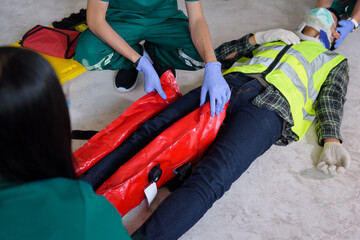 First aid for injuries in work accidents. Using the leg vacuum splint for support to loss of...