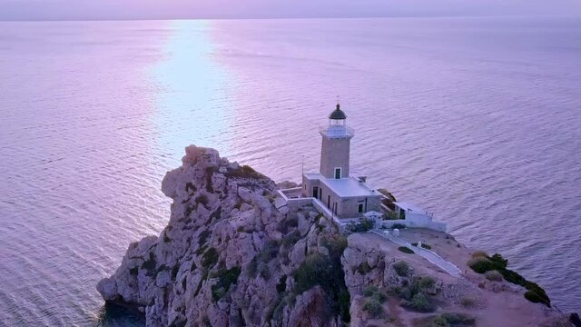 Drone rotating above Melagavi Lighthouse, high cliffs and sparkling sea of ​​Corinthia on the peninsula Peloponnese 