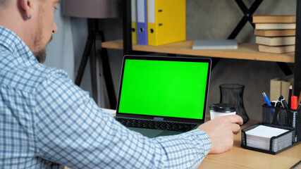 Fototapeta na wymiar Green screen mock up chroma key display monitor laptop computer concept: Businessman at home office listen company top manager employee online remote conference webcam video call business meeting chat