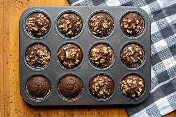 Healthy gluten free chocolate muffins with walnuts. Homemade, freshly baked goods with cocoa powder...