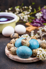 Process of painting Easter eggs in blue