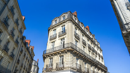 Fototapeta na wymiar Architecture typical of French tenement houses. Bright facade.