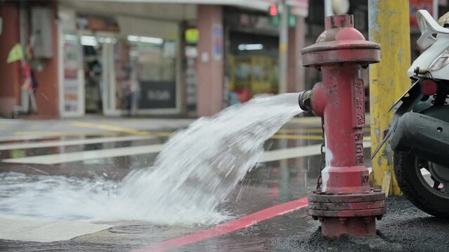 New Taipei City, Taiwan - January 29, 2021: Water comes out of the fire hydrant to lower the water pressure for maintenance purposes.