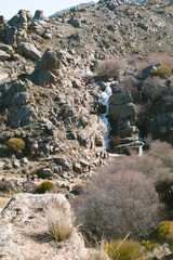 Group of tourists near a waterfall in Riofrio, Avila, Spain