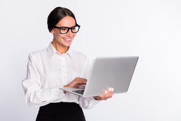 Photo of optimistic brunette hairdo lady hold laptop wear spectacles shirt isolated on grey color background