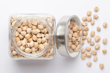 Close up of Organic chhole chana or Kabuli chana (Cicer arietinum) or whole white Bengal gram dal in a glass jar with Lid. Top view 