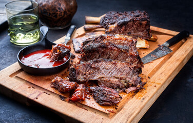 Traditional barbecue burnt chuck beef ribs marinated with spicy rub and served with a hot chili...