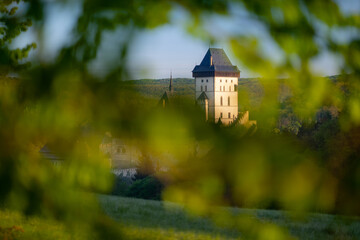 State castle Karlstejn, as viewed through the green leaves