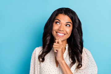 Photo of young happy curious lovely smiling minded afro girl look copyspace thinking isolated on blue color background