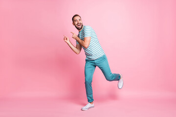 Full length body size view of attractive careful funky cheerful guy dancing having fun fooling isolated over pink pastel color background