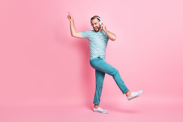 Fototapeta na wymiar Full length body size view of attractive cheerful guy listening bass stereo song dancing having fun isolated over pink color background