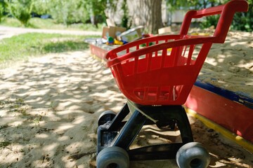 Play playground sand sandbox shadow. item red cart, street truck.