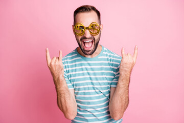Close-up portrait of nice cheerful guy wearing us dollar specs having fun showing horn sign...