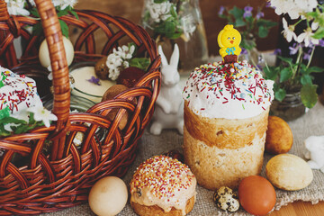 Easter food,  easter eggs, beets, cheese, butter, ham,  Easter bread and basket on rustic table