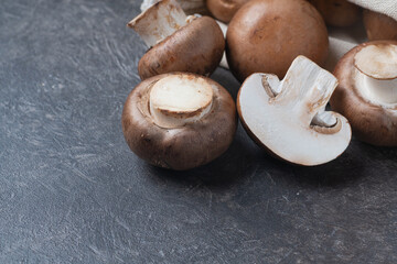 Royal mushrooms close-up lie on a dark background. Pouch visible