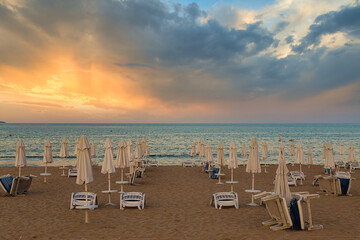 morning , sunbeds and parasols on the beach,