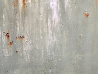 texture of old painted rusty grey wall or garage door with peeling and cracked paint and corrosion