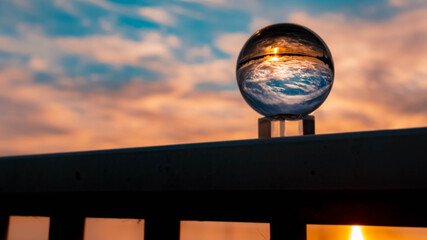 Crystal ball sunset shot with reflections at Plattling, Bavaria, Germany