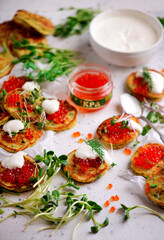 Potato pancakes with caviar.top view.style rustic