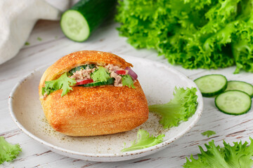Delicious homemade sandwich with tuna, radish, cucumber, red onion and lettuce salad on a ciabatta bun. Healthy breakfast, lunch or dinner for gourmets. Mediterranean cuisine. Selective Focus
