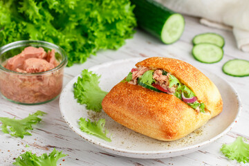 Delicious homemade sandwich with tuna, radish, cucumber, red onion and lettuce salad on a ciabatta bun. Healthy breakfast, lunch or dinner for gourmets. Mediterranean cuisine. Selective Focus