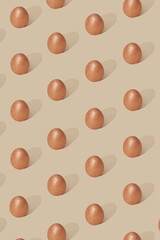 Egg pattern on a beige background. Egg painted with face powder. Easter 2021 concept. Minimal luxury trendy style with popular gentle colours.