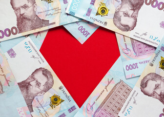 A heart lined with Ukrainian hryvnia banknotes