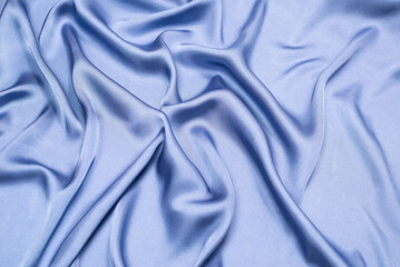 Blue silk or satin luxury fabric texture. Top view.