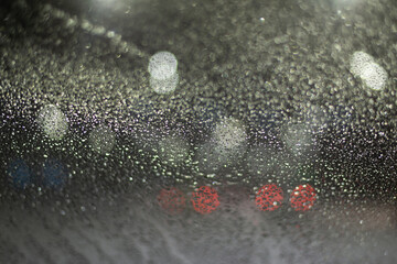 Blurred background with raindrops and lights.