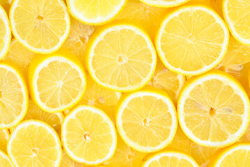 A slices of fresh juicy yellow lemons.  Texture background, pattern.