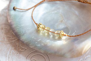 Citrine gemstone beads tiny elegant bracelet on natural shell background