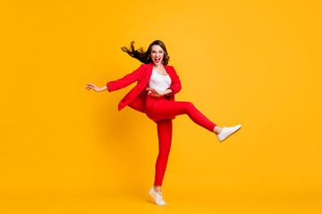 Fototapeta na wymiar Full length photo of pretty classy girl dance open mouth wear red suit jacket trousers sneakers eyewear isolated yellow color background