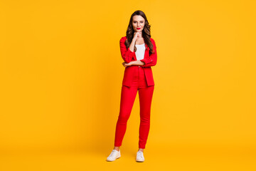 Fototapeta na wymiar Full length photo of cute classy lady finger chin wear red suit blazer pants sneakers spectacles isolated yellow color background