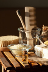 Zero waste and sustainable lifestyle concept. Eco-friendly bathroom accessories. Handmade soap, organic essential oil, sea salt, wooden background. Home body and face care. Contrast light, close-up